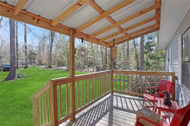 wooden terrace featuring a lawn