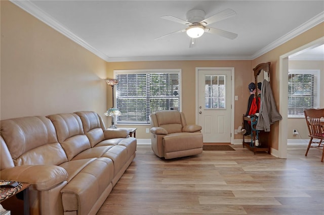 living room with plenty of natural light, ceiling fan, and crown molding