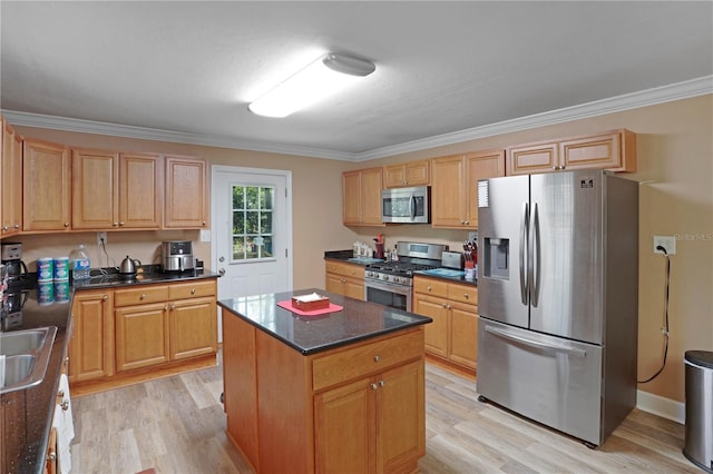 kitchen with light wood-type flooring, a center island, stainless steel appliances, and crown molding