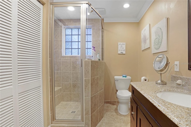 bathroom with vanity, a shower with door, crown molding, tile patterned flooring, and toilet