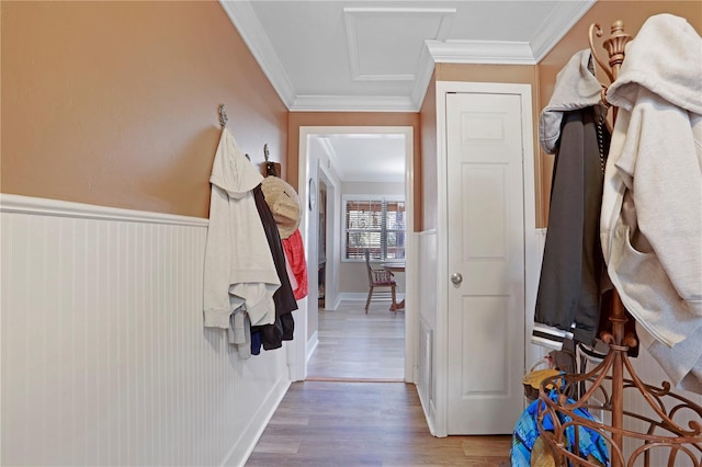 mudroom with wood-type flooring and ornamental molding