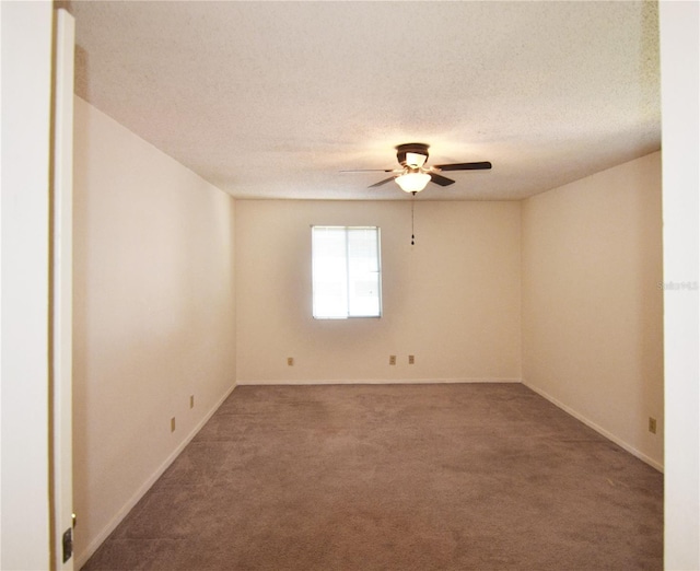 carpeted empty room with a textured ceiling and ceiling fan