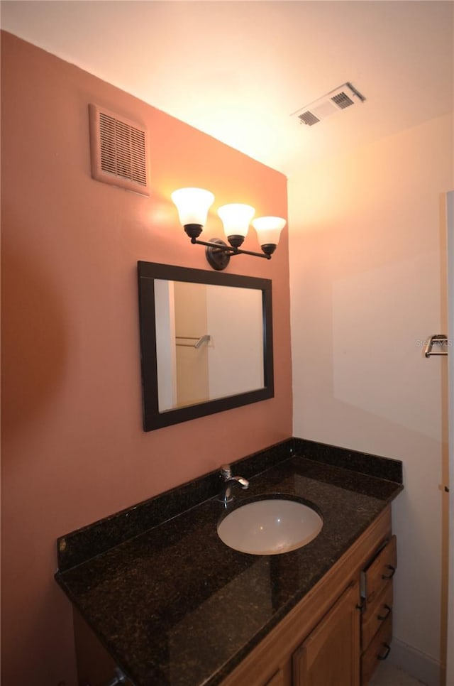 bathroom featuring vanity and a notable chandelier