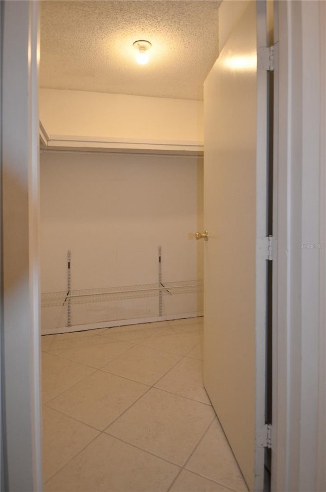 spacious closet with tile patterned floors