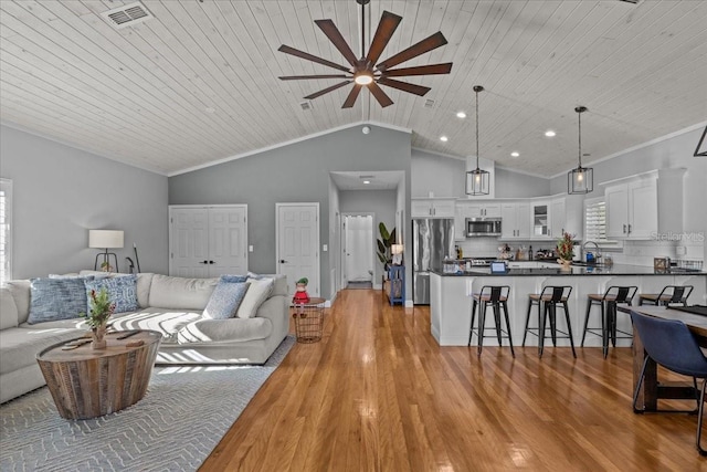 living room featuring ceiling fan, wooden ceiling, light hardwood / wood-style flooring, vaulted ceiling, and ornamental molding