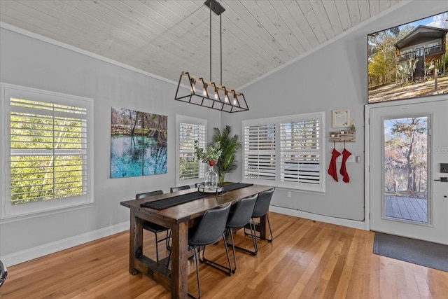 dining room featuring crown molding, light hardwood / wood-style flooring, lofted ceiling, and wood ceiling