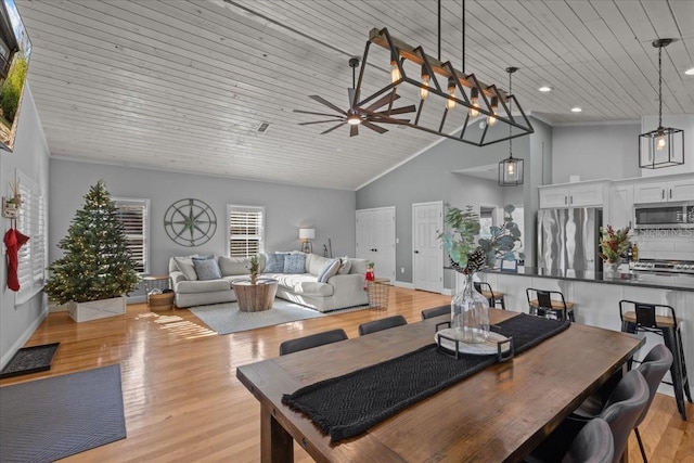 dining area featuring ceiling fan, light wood-type flooring, wooden ceiling, and high vaulted ceiling