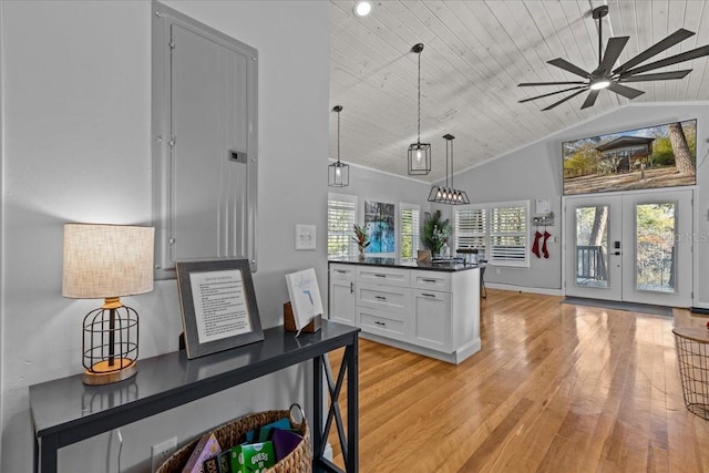 kitchen featuring wooden ceiling, french doors, white cabinets, hanging light fixtures, and a wealth of natural light