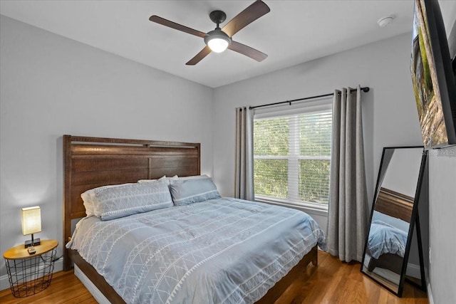 bedroom featuring hardwood / wood-style floors and ceiling fan