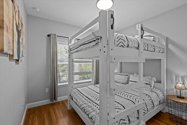 bedroom with dark hardwood / wood-style floors