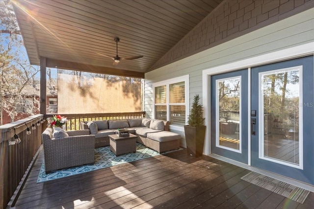 deck featuring an outdoor living space and ceiling fan