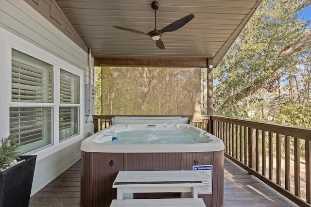 deck featuring ceiling fan and a hot tub