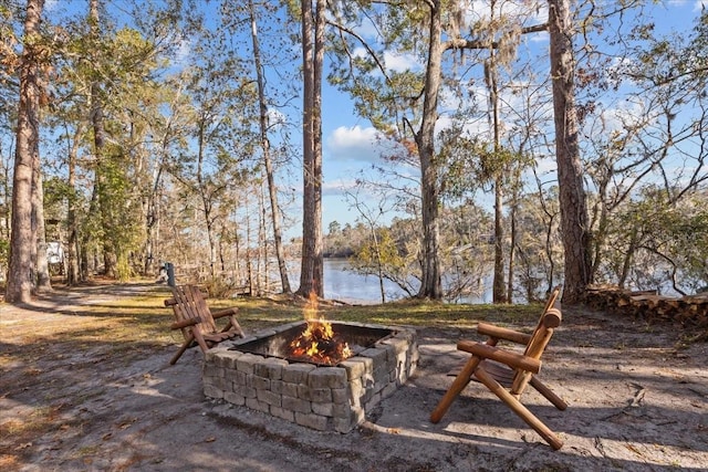 view of patio featuring a fire pit and a water view