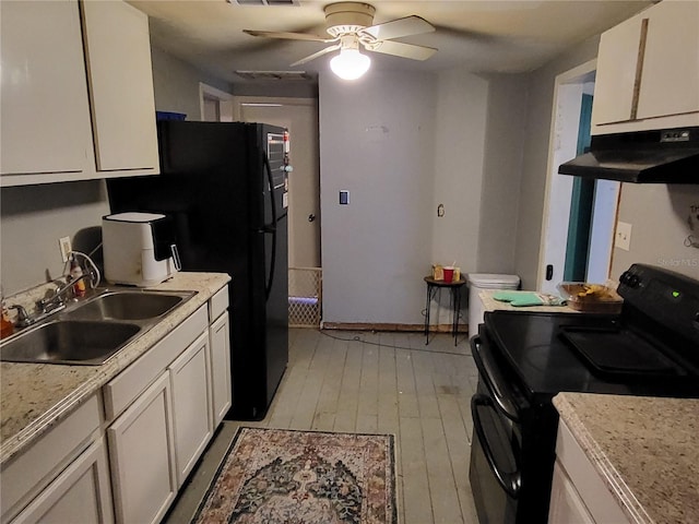 kitchen featuring ceiling fan, sink, light hardwood / wood-style floors, white cabinets, and black appliances