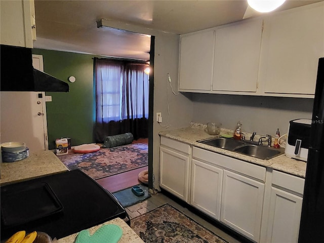 kitchen featuring white cabinets and sink