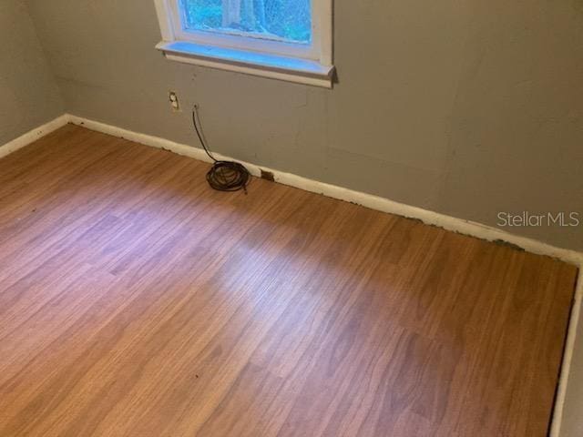 empty room with wood-type flooring