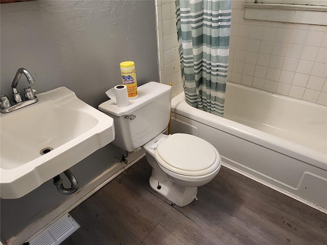 full bathroom with sink, toilet, shower / tub combo with curtain, and hardwood / wood-style flooring