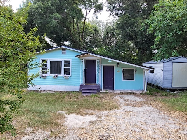 view of front of home with a storage shed