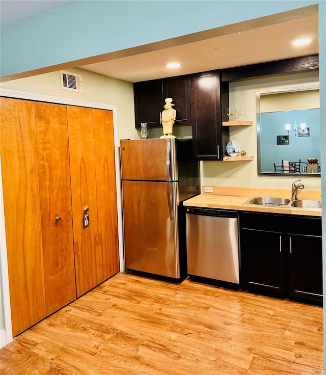 kitchen featuring sink, stainless steel appliances, and light hardwood / wood-style floors