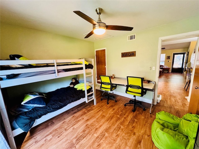 bedroom with ceiling fan and wood-type flooring