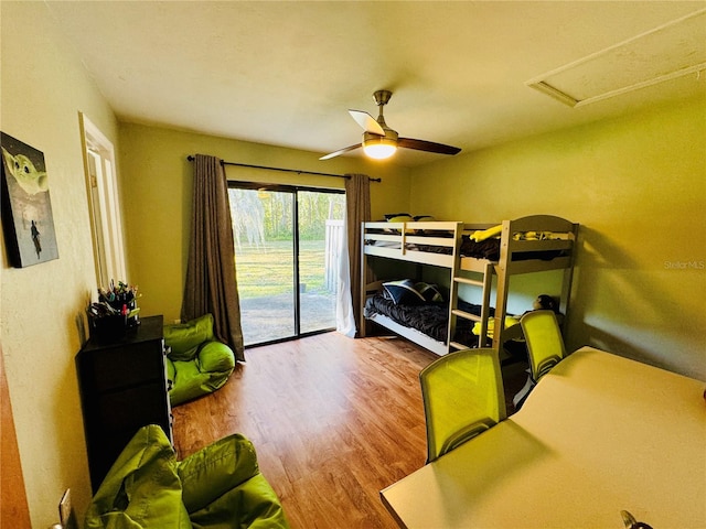 bedroom featuring hardwood / wood-style floors, access to exterior, and ceiling fan