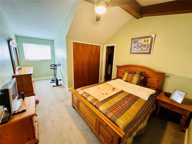 carpeted bedroom featuring ceiling fan, a closet, and vaulted ceiling with beams