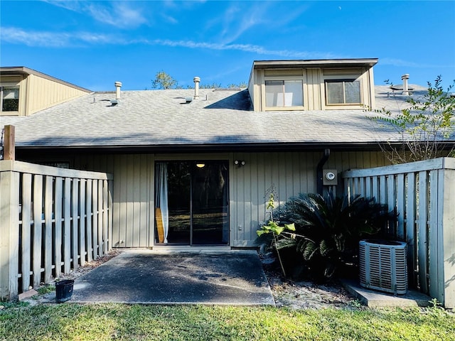 rear view of property with a patio and cooling unit