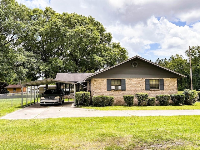 single story home featuring a front yard, a carport, and cooling unit