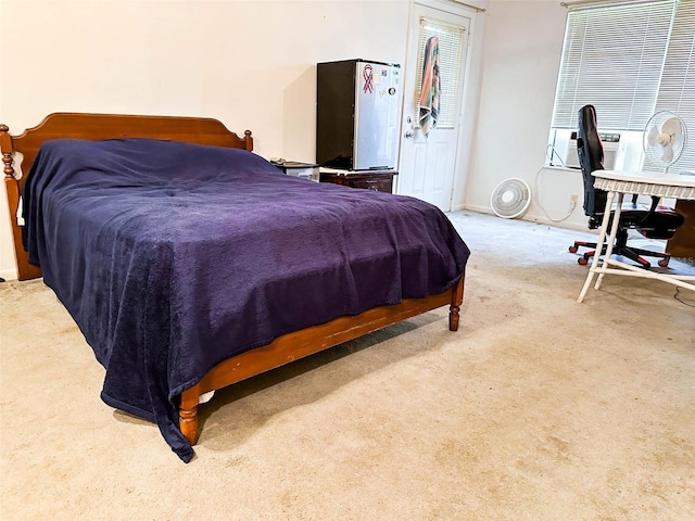 bedroom with stainless steel fridge and carpet flooring