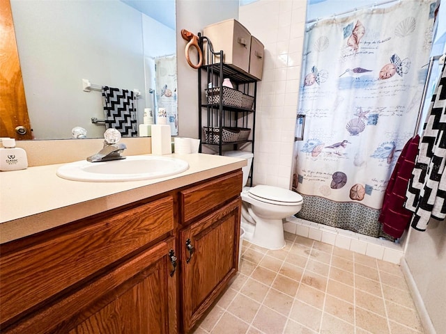 bathroom featuring toilet, vanity, and a shower with curtain