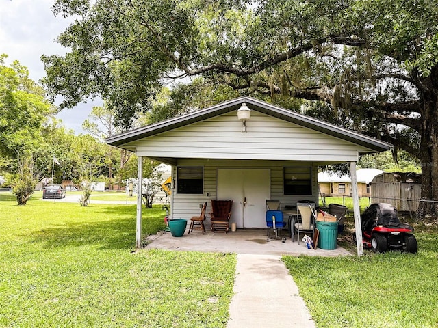 exterior space featuring a carport and a lawn