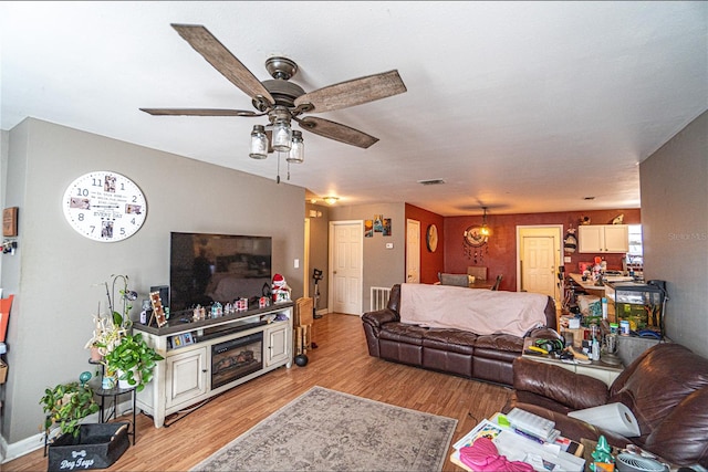 living room featuring light wood-type flooring and ceiling fan