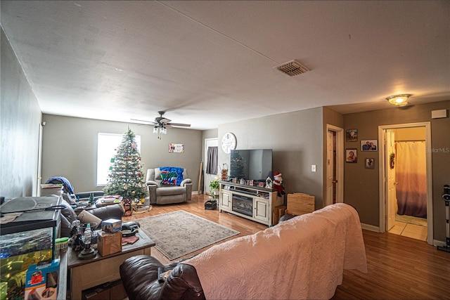 living room featuring hardwood / wood-style floors and ceiling fan