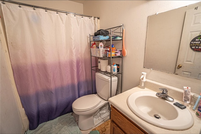 bathroom with vanity, toilet, and walk in shower