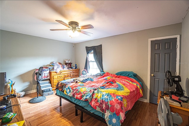 bedroom with ceiling fan and hardwood / wood-style floors