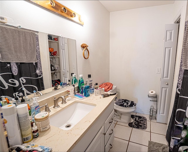 bathroom featuring tile patterned flooring, vanity, and toilet