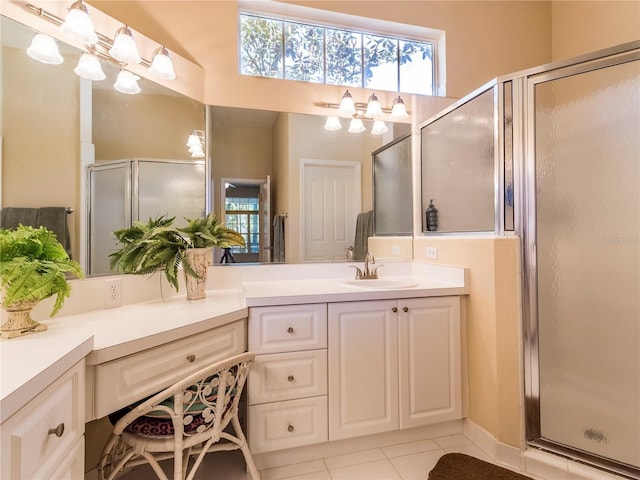 bathroom featuring tile patterned floors, a shower with door, and vanity