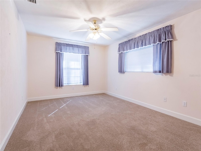 spare room with carpet flooring and ceiling fan