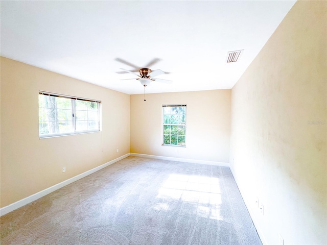 8305 SW 16th Pl, Gainesville, FL 32607 - spare room with plenty of natural light, a ceiling fan, carpet, and baseboards
