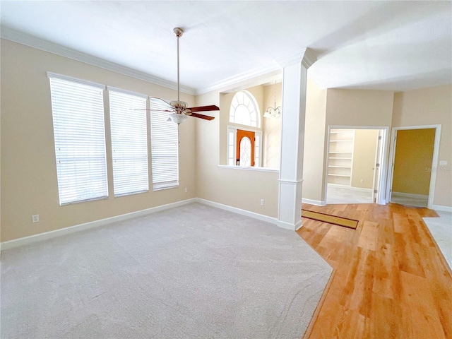 8305 SW 16th Pl, Gainesville, FL 32607 - empty room featuring crown molding, baseboards, ceiling fan, light wood finished floors, and built in features
