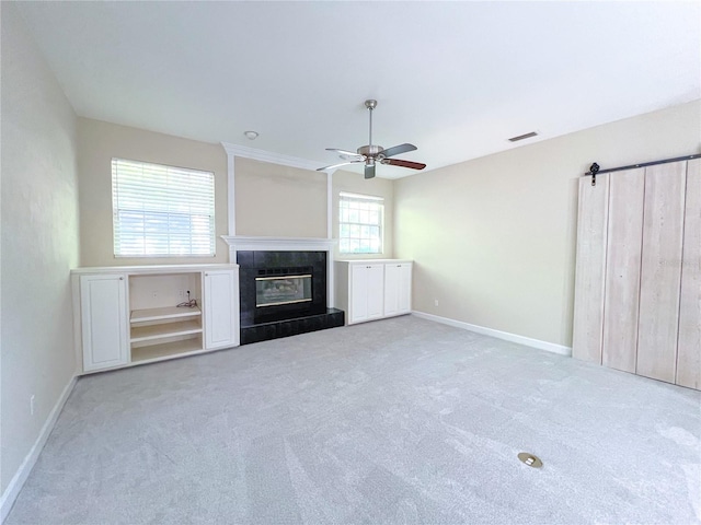 8305 SW 16th Pl, Gainesville, FL 32607 - unfurnished living room with ceiling fan, carpet, a glass covered fireplace, and baseboards
