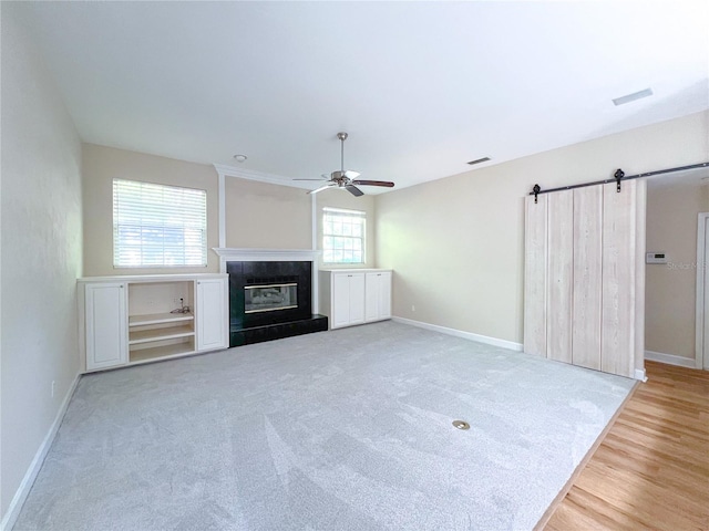 8305 SW 16th Pl, Gainesville, FL 32607 - unfurnished living room with a ceiling fan, baseboards, and a glass covered fireplace