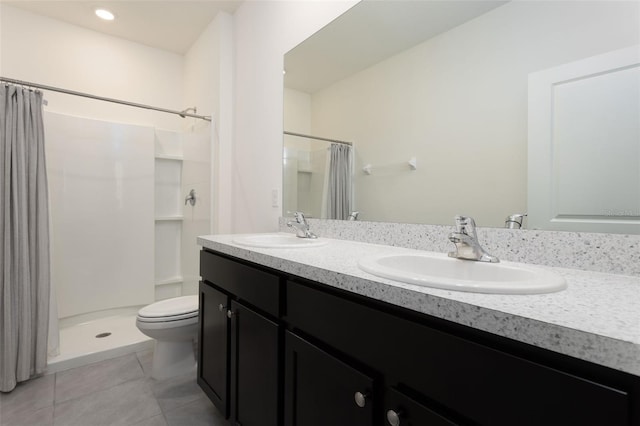 bathroom featuring a shower with shower curtain, vanity, toilet, and tile patterned flooring