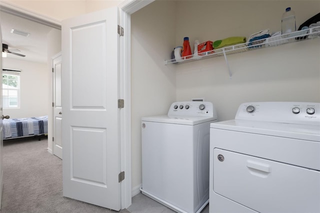 laundry room featuring independent washer and dryer, light colored carpet, and ceiling fan