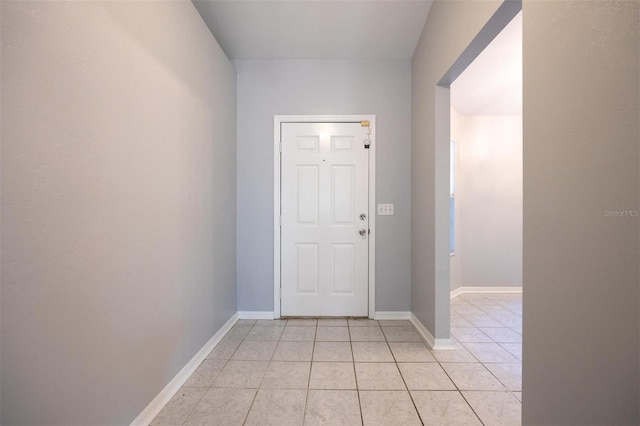 doorway with light tile patterned flooring