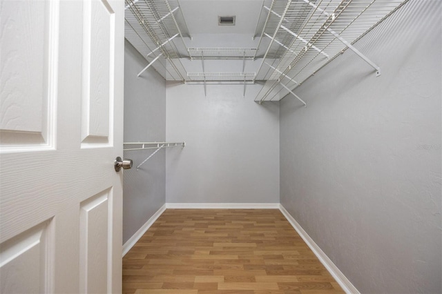 walk in closet featuring hardwood / wood-style flooring