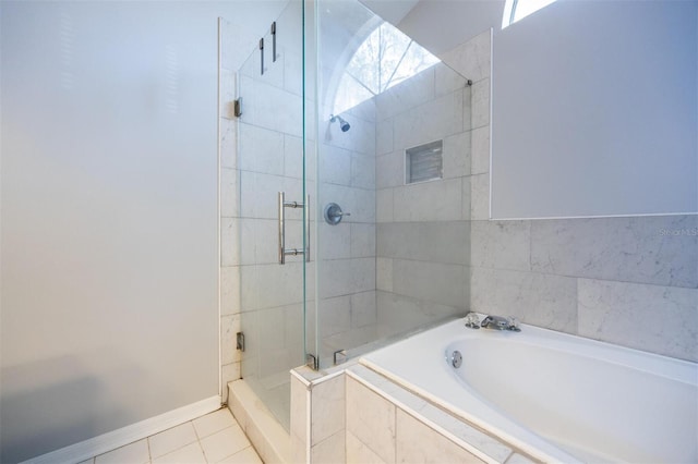 bathroom featuring tile patterned floors and shower with separate bathtub