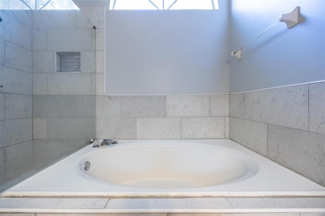 bathroom featuring a relaxing tiled tub