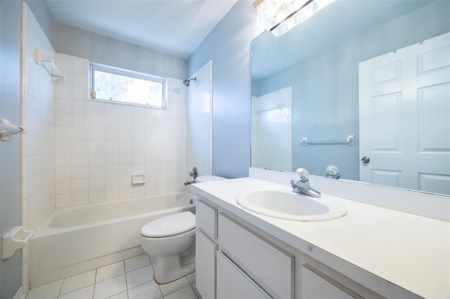 full bathroom with tile patterned flooring, vanity, tiled shower / bath combo, and toilet