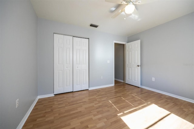 unfurnished bedroom featuring a closet, ceiling fan, and hardwood / wood-style flooring